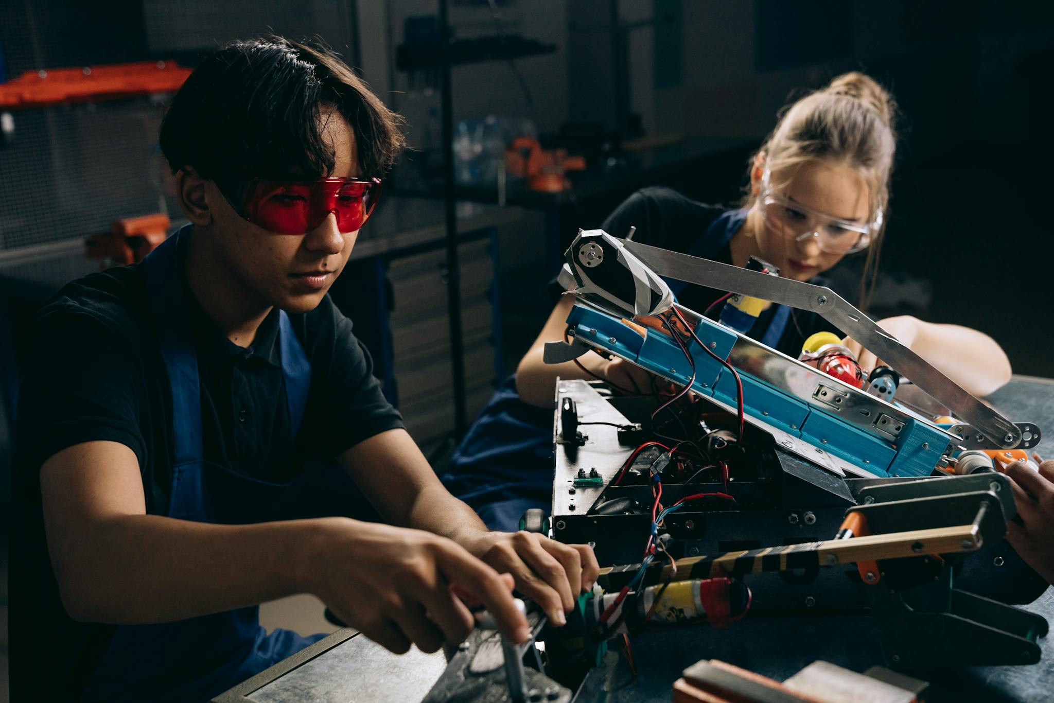Two Young Engineers Working On Robotic Equipment